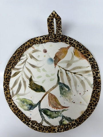Reverse view of a Scrappy Potholder with botanical fabric and leopard-print binding