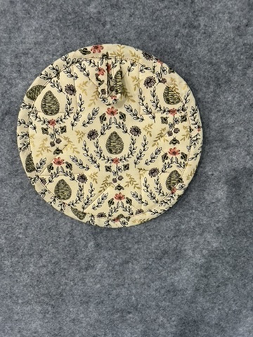 Reverse view of a Scrappy Potholder with a traditional pinecone and botanical print
