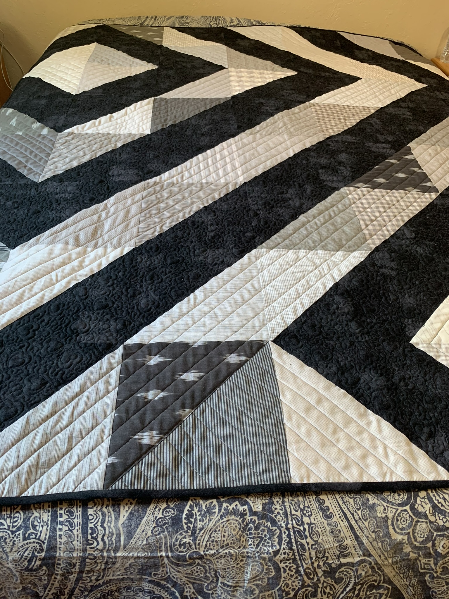 Alternate full view of Emma’s Quilt showing the geometric front and patterned backing
