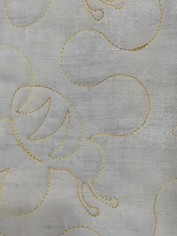 Close-up of the flowing yellow stitchwork on Barney’s Quilt