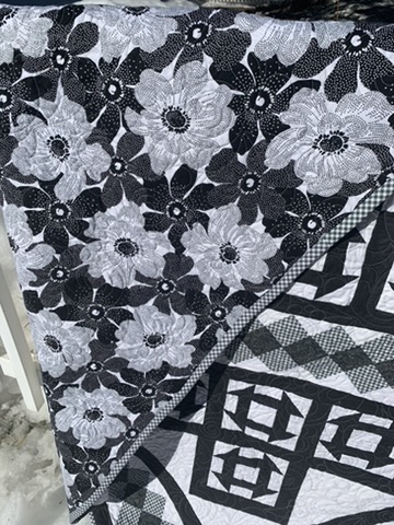 Floral fabric and geometric patchwork detail on CHURN DASH
