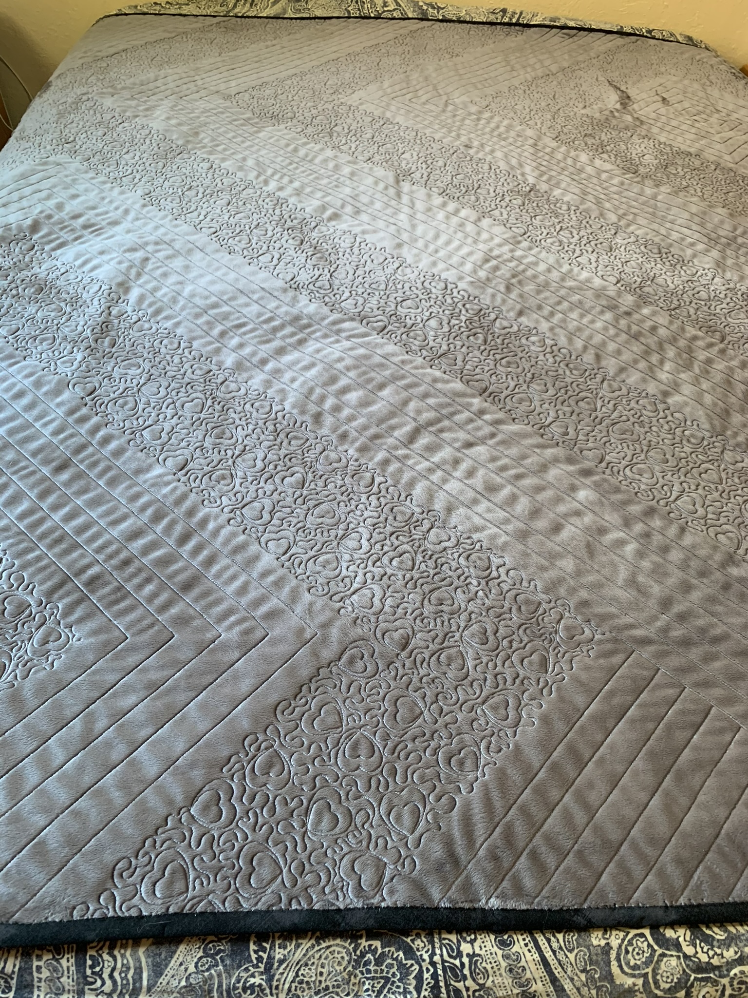 Reverse view of Emma’s Quilt showing heart-filled quilting and geometric stitched lines