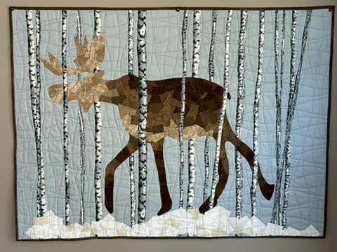 Moose Wall Hanging by Michele Urbany Neely Puluti, showing a pieced moose among birch trees and snow