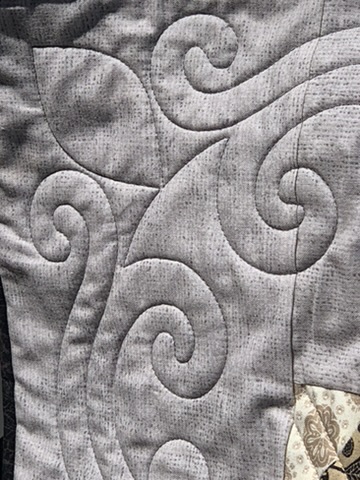 Close-up of sweeping gray scroll quilting on the Pam and Jack quilt