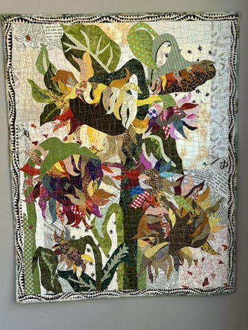 Sunflowers Wall Hanging by Michele Urbany Neely Puluti, featuring layered sunflower appliqué, leaves, stems, and multicolored patterned fabrics