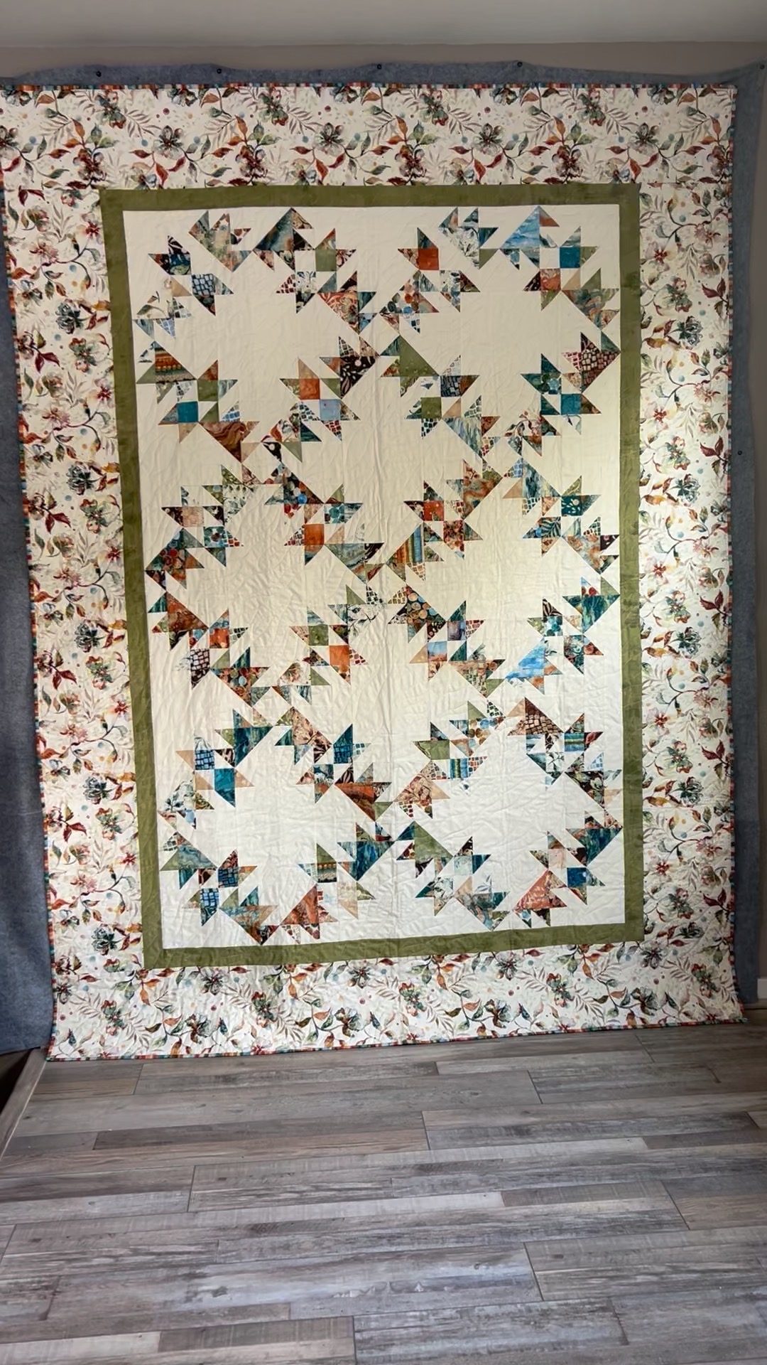 Swallows Quilt by Michele Urbany Neely Puluti, featuring flocks of multicolored pieced swallows on a cream field with a botanical border