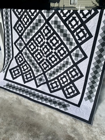 Full view of Michele Urbany Neely Puluti’s black-and-white CHURN DASH quilt
