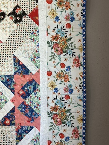 Close-up of the floral border, patterned star block, and quilting on My Favorite Quilt