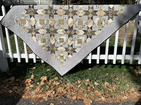 Full view of Michele Urbany Neely Puluti’s Pam and Jack quilt in warm neutral, gray, and charcoal fabrics
