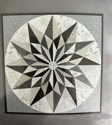 Zen Chic Star Wall Hanging by Michele Urbany Neely Puluti, featuring a sharply pieced black, white, and gray compass star within a circular field